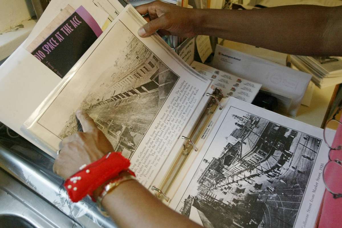 Lisa Lee of Oakland, looks through records of her family's history in her Oakland home on Thursday, April 4, 2002. Her family, once slaves in the United States, might be eligible to reparations for their having been enslaved, if a lawsuit is found to be actionable. (Carlos Avila Gonzalez / San Francisco Chronicle)